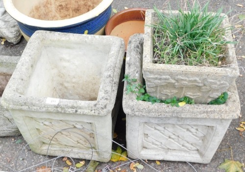 A pair of reconstituted stone planters, each square set, with patched star design, 36cm high, the top 34cm x 34cm, and a smaller reconstituted stone planter with flower decoration. (3)