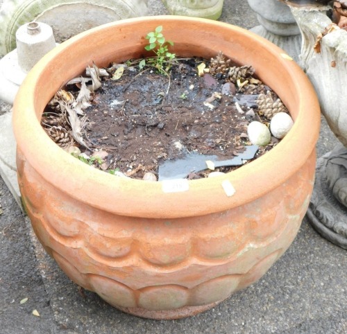 A terracotta planter, of arched design with a lobed top, 45cm high, 51cm diameter.