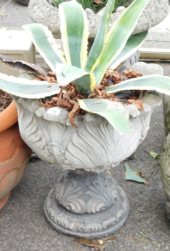 A reconstituted stone garden urn, with leaf moulded top, on a stepped and darted base, 53cm high, 46cm diameter.