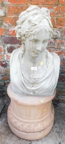 A reconstituted stone bust of a lady, on terracotta circular plinth, 91cm high, the plinth 45cm diameter.
