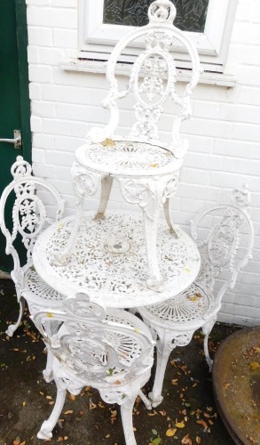 A cast aluminium garden table and four chairs, white painted.