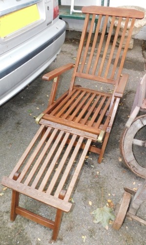 A teak garden lounger.