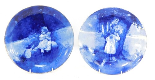 Two Royal Doulton blue and white cabinet plates, each depicting a young girl, each 23.5cm diameter.