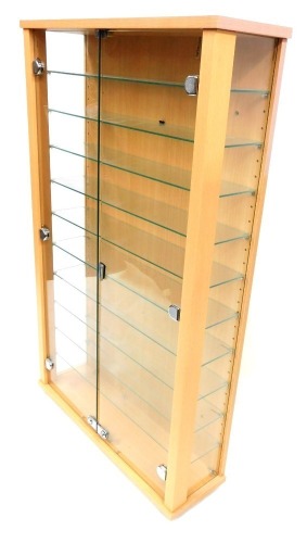 A beech collectors cabinet, with nine shelves and two swing doors, in a beech finish, 110cm high, 68cm wide, 20cm deep.