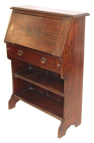 A 20thC oak writing desk or students bureau, with fall flap and single drawer, with bookcase base, 103cm high, 76cm wide, 29cm deep.