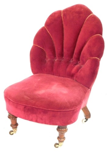 A Victorian nursing chair, with pink velvet button back upholstered shell shaped back, on walnut turned legs, 80cm high, 50cm wide, 48cm deep.