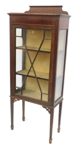 An Edwardian mahogany display cabinet, with moulded corners, single astragal glazed door with two gold lined shelves, on moulded legs, 148cm high, 61cm wide, 30cm deep.