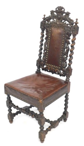 A carved oak Carolean style dining chair, with moulded crest top with two lions, on barleytwist column supports with brown leather inset seat, 108cm high, 46cm wide, 44cm deep. (AF)