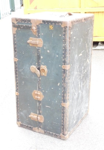 A vintage steel strap work bound travel trunk, which opens into a compactum wardrobe, 103cm x 59cm x 54cm.